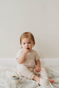 Organic cotton ribbed knit romper in "Oat"